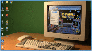 Desktop clássico do Windows XP com papel de parede verde Bliss ao fundo, janela do 3D Pinball Space Cadet aberta em destaque, mouse antigo e teclado branco da época, monitor CRT vintage, atmosfera nostálgica dos anos 2000, iluminação suave e quente, estilo fotográfico realista.